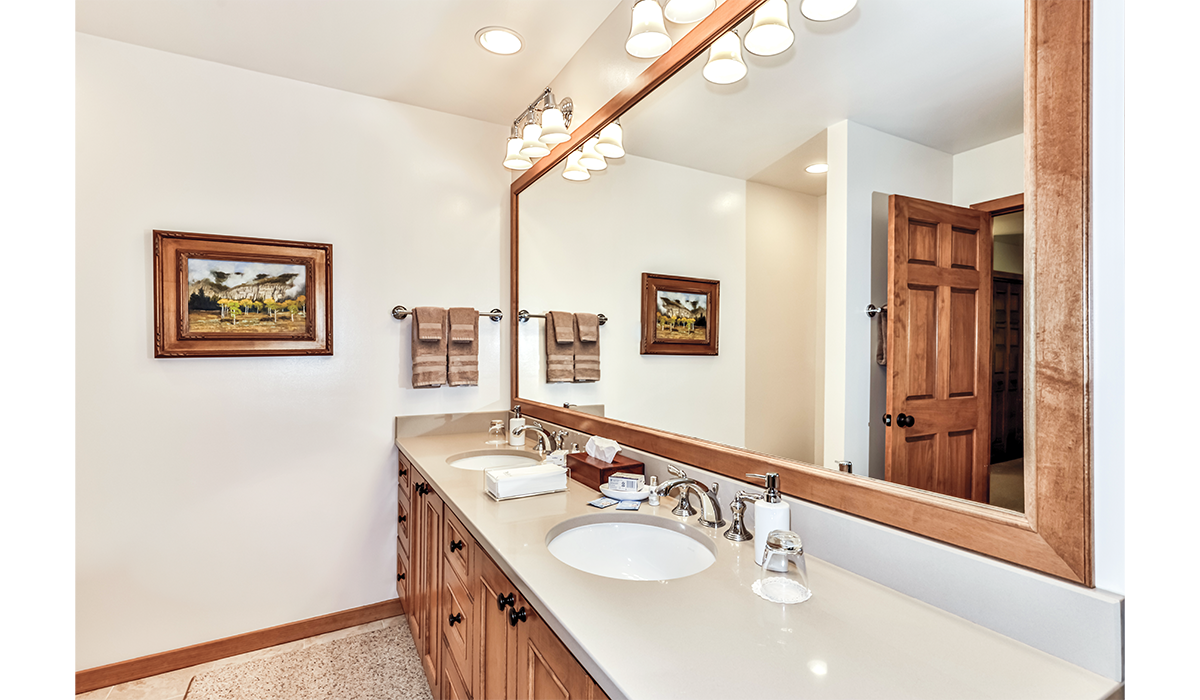 Double-sink bathroom with extra lighting and oversized mirror.