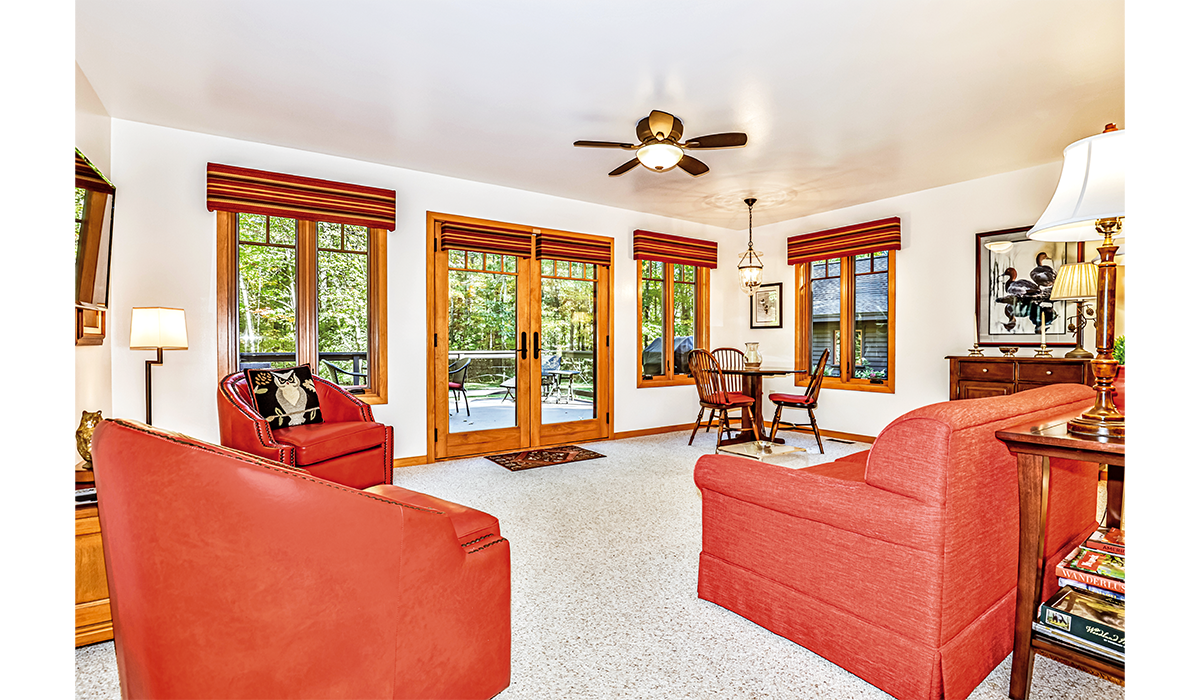 Living room faces the patio with beautiful views of the Northwoods.