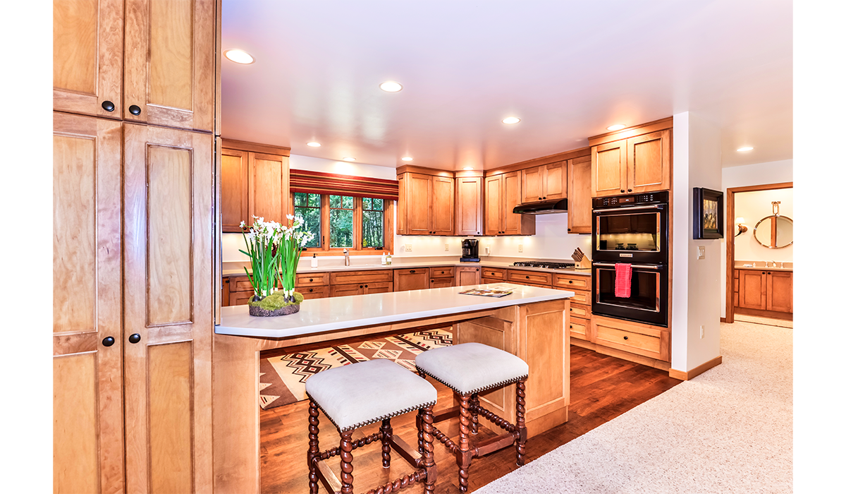 Spacious full-size kitchen with double oven and breakfast bar.