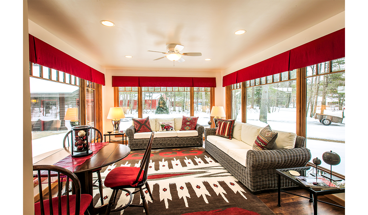 Enjoy a peaceful, relaxing snow day in the cozy sunroom.
