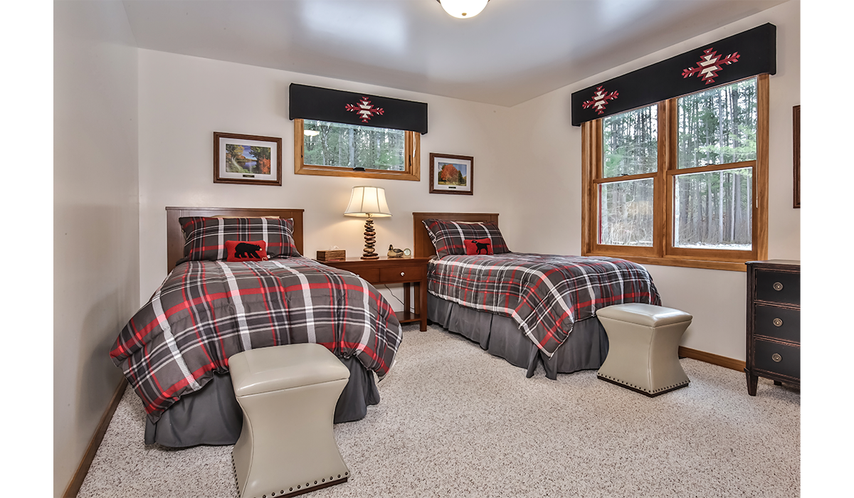 Third bedroom with twin beds has an upscale, rustic vibe.