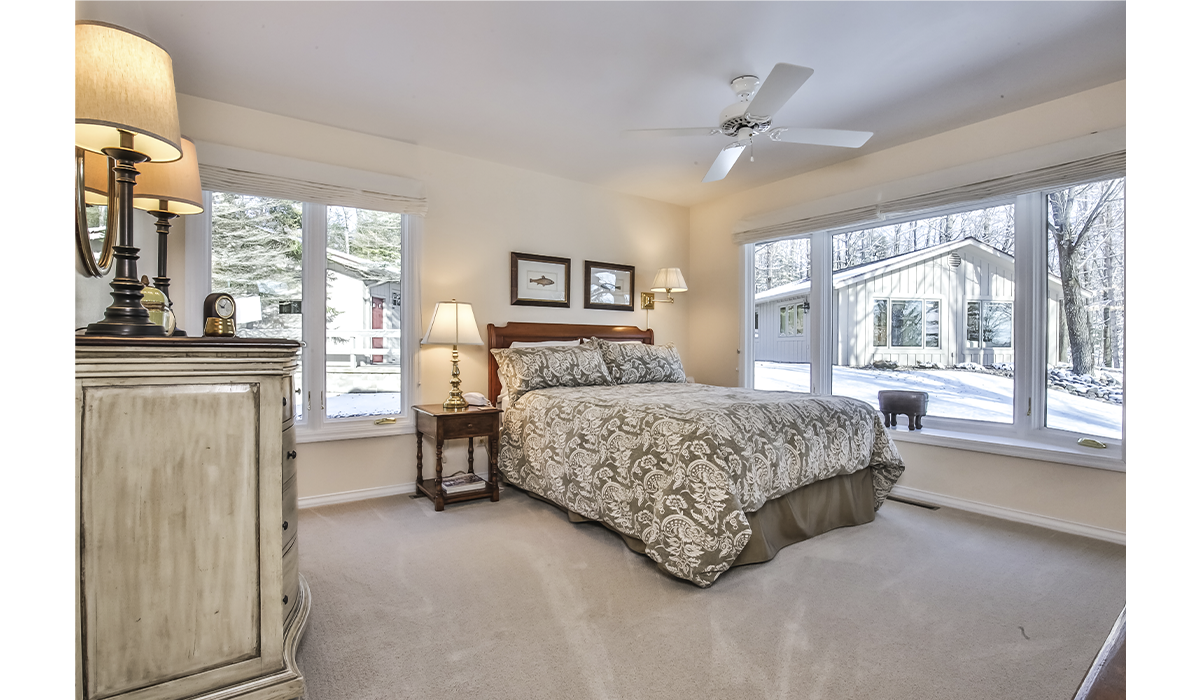 One of three bedrooms with large casement windows.