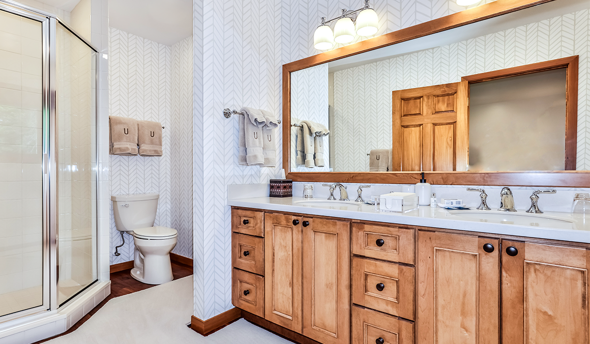 Roomy bathroom with double sink and full-size mirror.