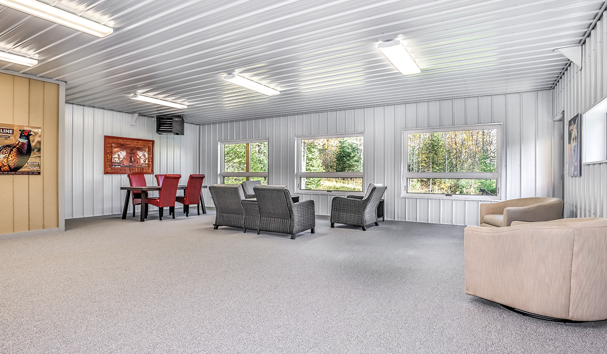 Large heated garage with comfortable gathering area.