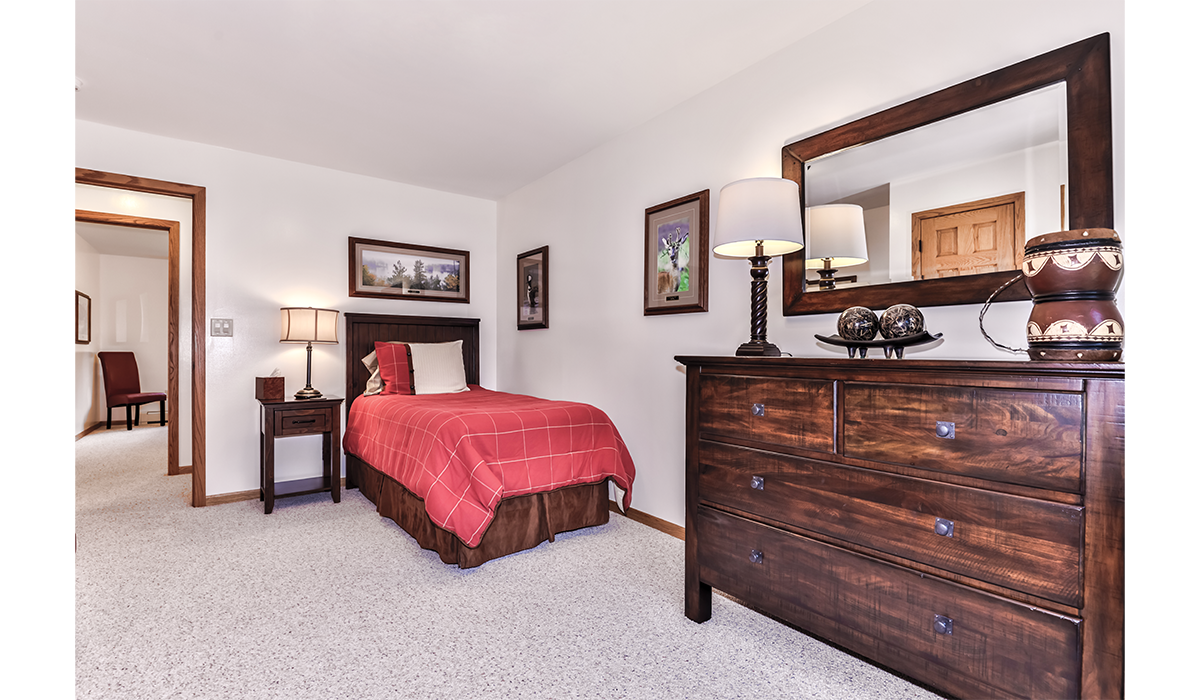 Single-bed bedroom offers the same wood craftsmanship.