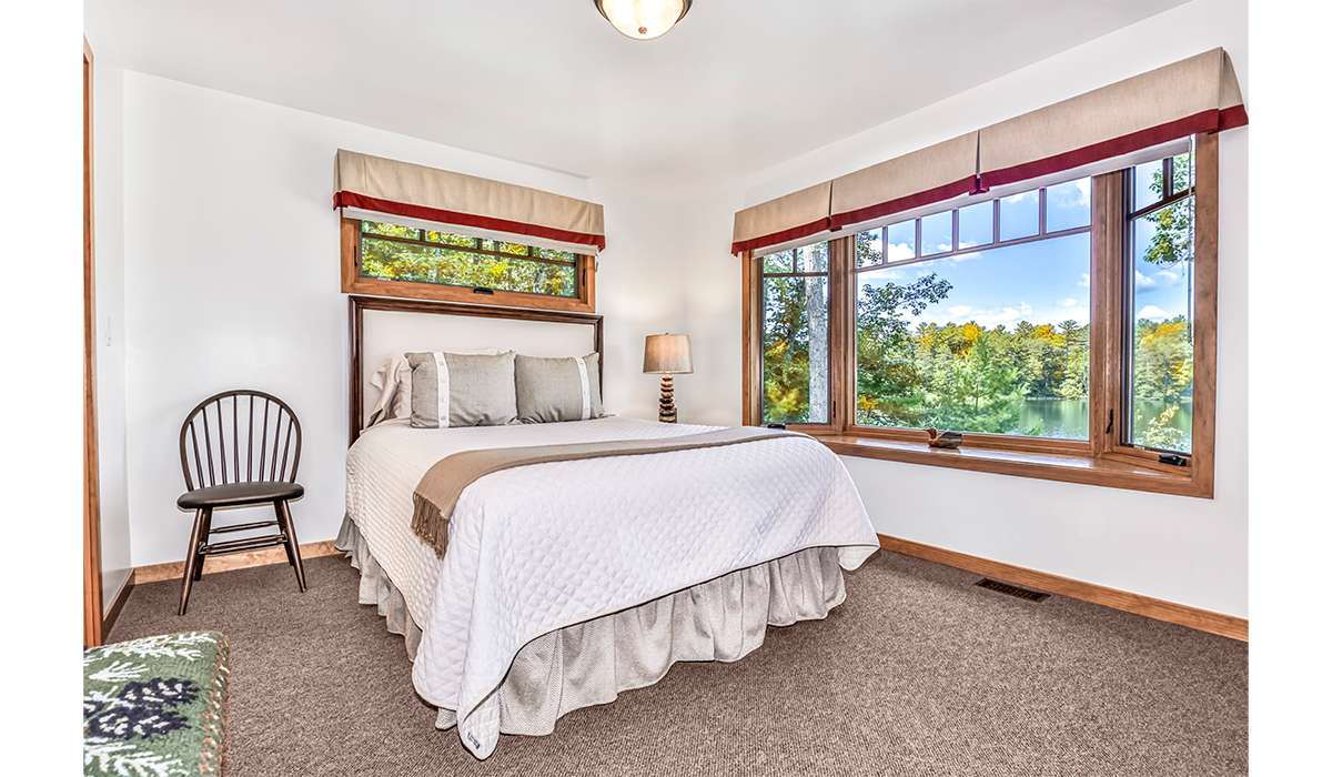 Large bedroom windows invite the scenery in.