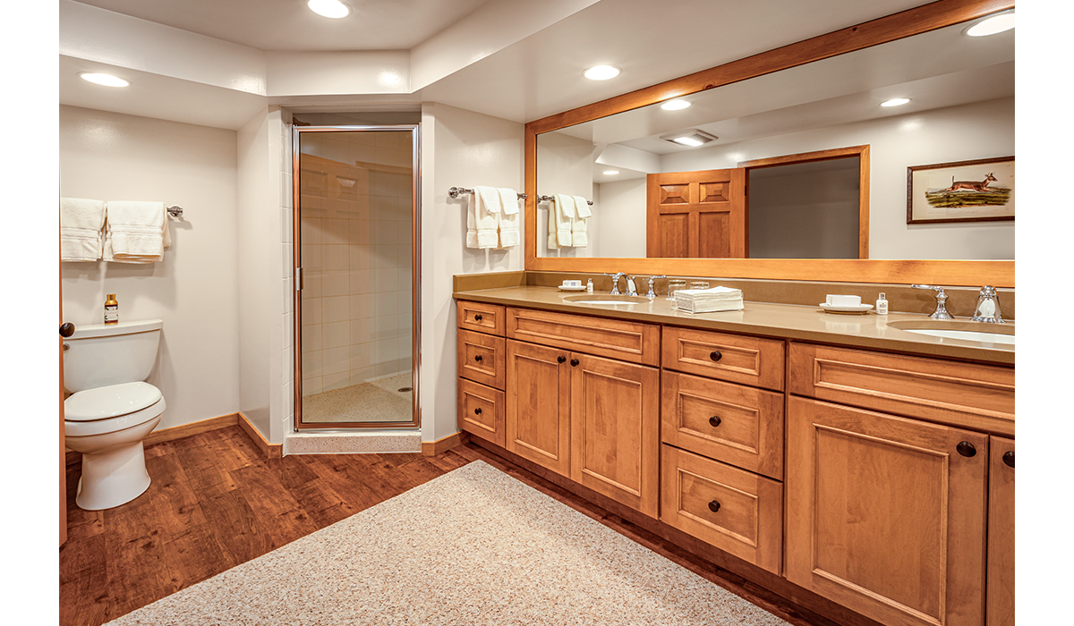 Double-sink bathroom with extra lighting and oversized mirror.
