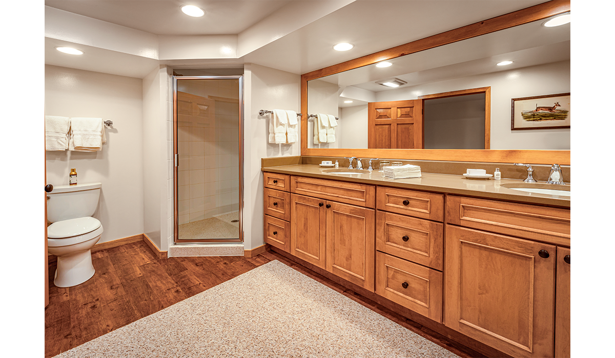 Double-sink bathroom with extra lighting and oversized mirror.