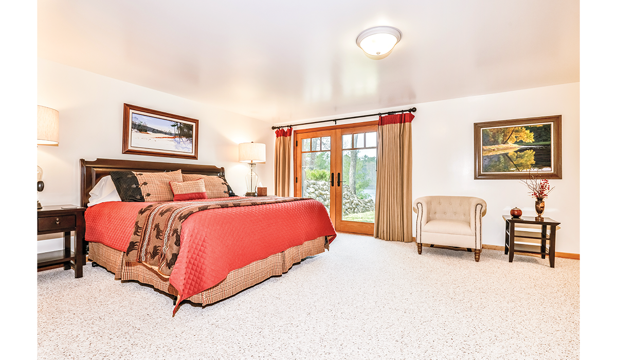 Spacious bedroom with French doors that lead to the lake.